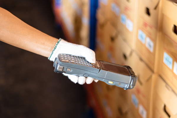 hand held barcode scanner scanning product boxes